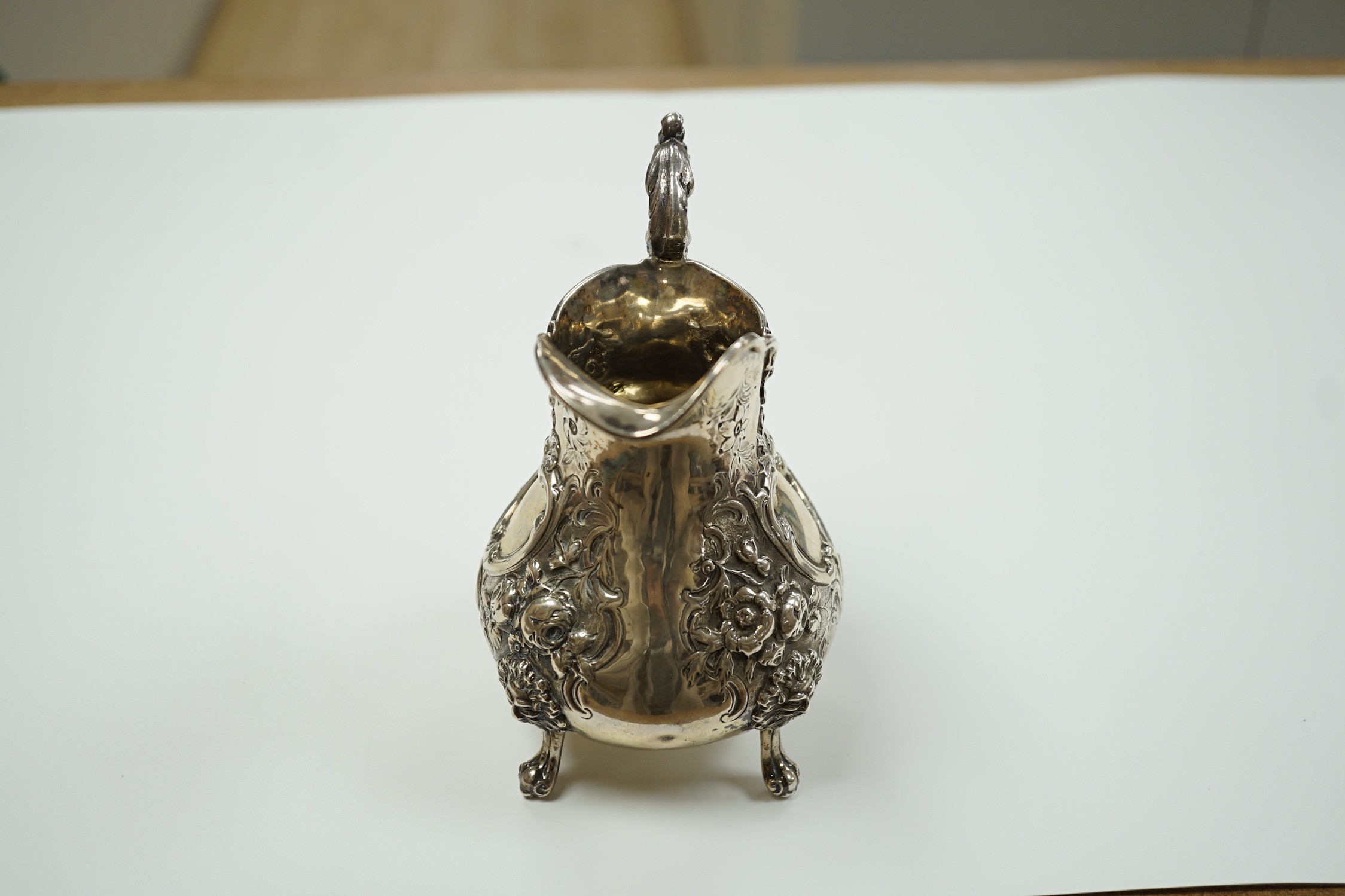 A Victorian embossed silver baluster cream jug, Robert Harper, London, 1862, height 15.1cm, 8.6oz.